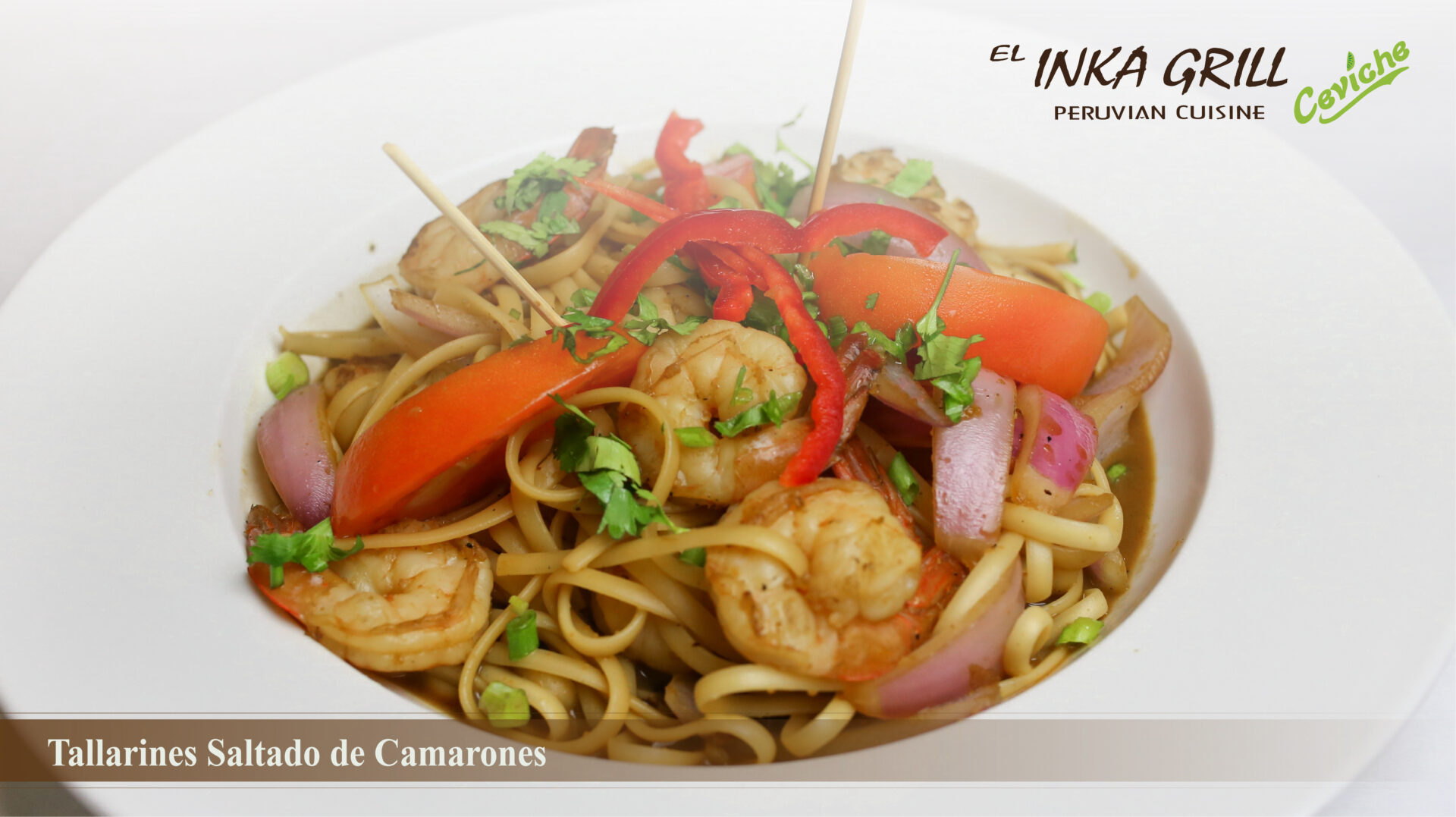 A bowl of noodles with shrimp and vegetables.