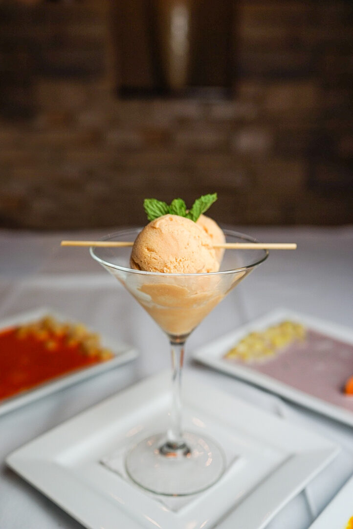 A glass of ice cream with toothpicks in it.