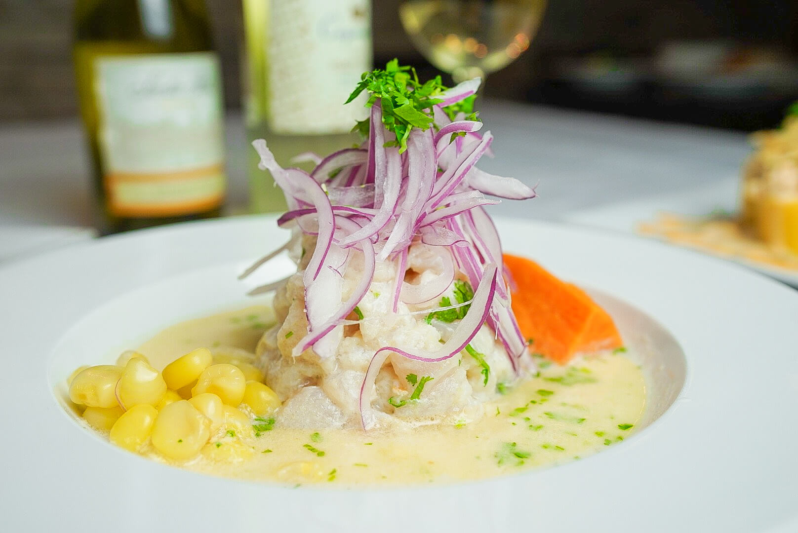 A plate of food with onions and corn.