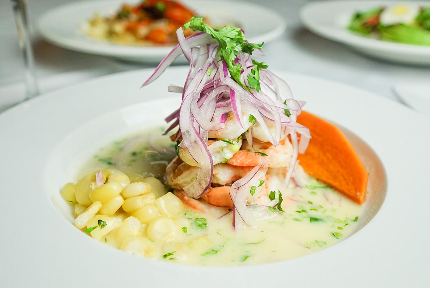 A plate of food with shrimp and corn.