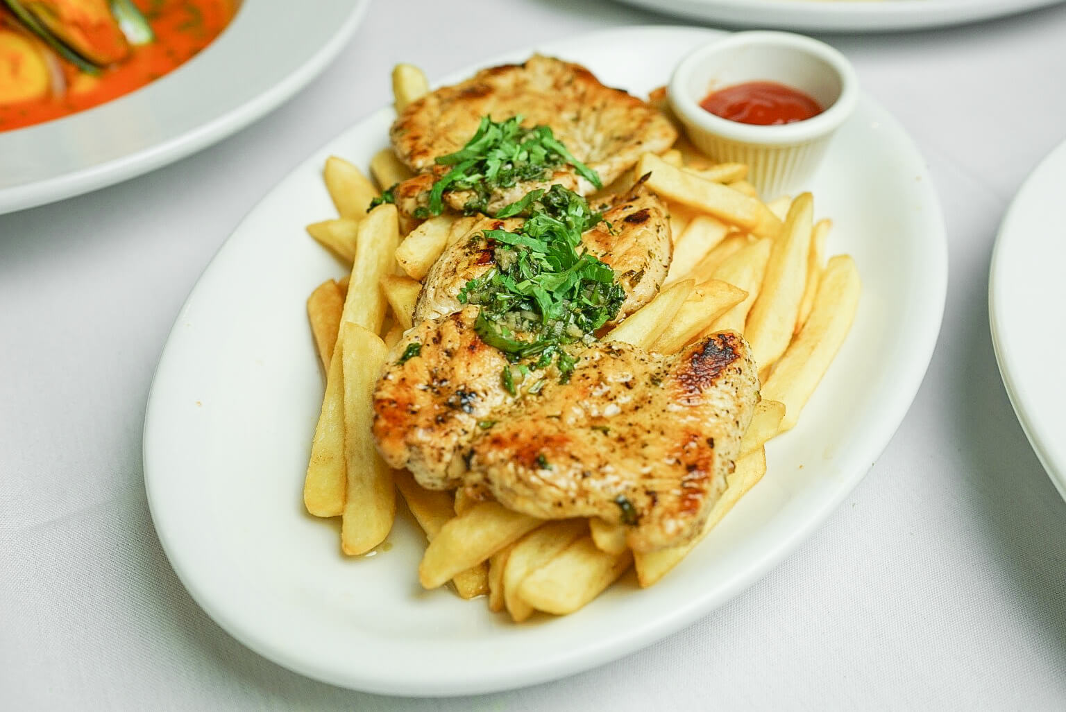 A plate of food with french fries and meat.