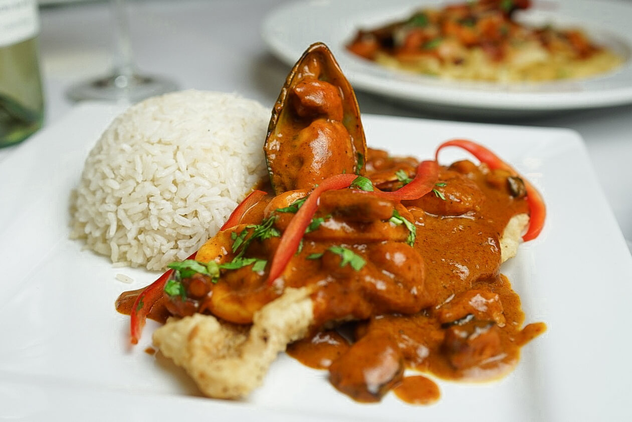 A plate of food with rice and meat on it.