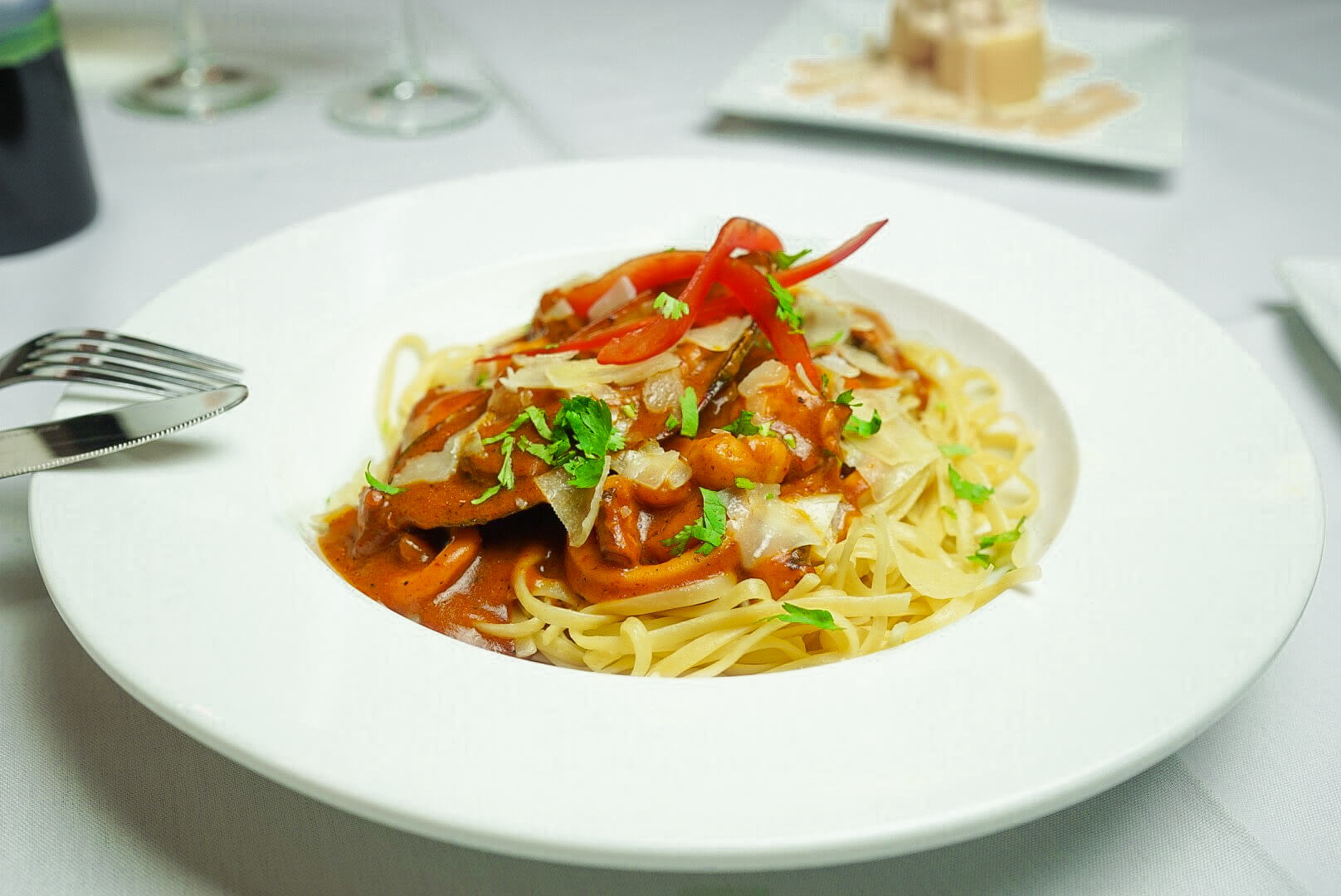 A plate of pasta with meat and vegetables.