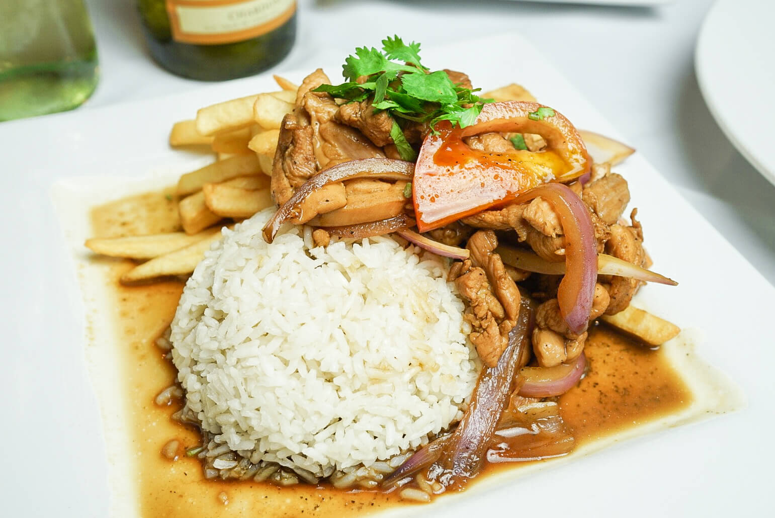 A plate of food with rice and meat on it.