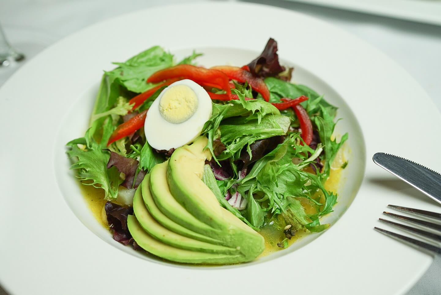 A plate of food with avocado and eggs.